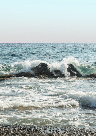 summer sea water with rocks and waves in Greeceの写真素材