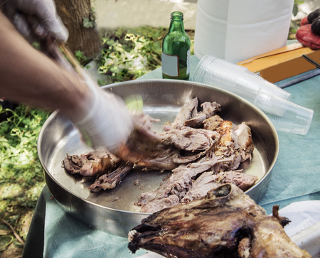 Easter big lamb roasted on a spindle in a metal bowlの写真素材