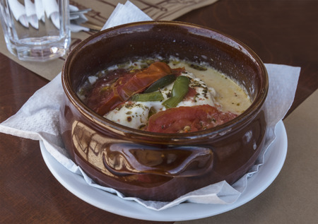 traditional greek saganaki with cheese and tomatoes on the ceramic plateの写真素材