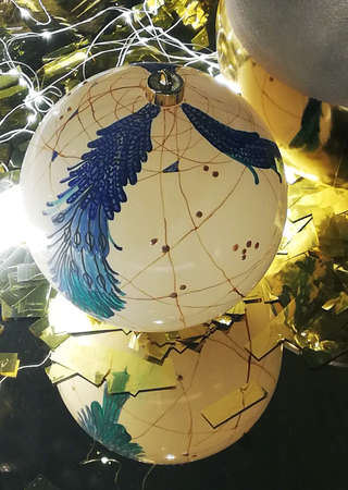 one christmas ball with a picture of a christmas tree in reflectionの写真素材