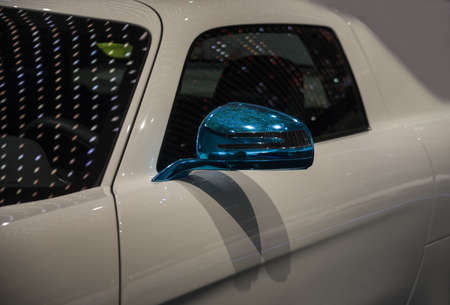big white car with blue metallic rearview mirrorの写真素材