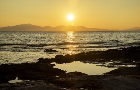 nice sea coast with stones at sunset, Greeceの写真素材