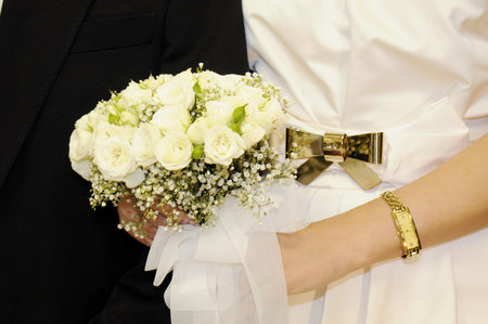 one wedding bouquet in the hands of the brideの写真素材