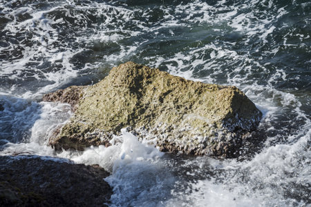 Rocky stone in the Mediterranean Sea on the coast of the island of Aegina in summer. Greeceの写真素材