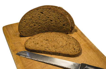 rye bread cut into slices with knife isolated on white backgroundの写真素材