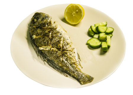 Grilled dorado on a plate served with vegetablesの写真素材