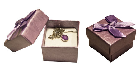 Gift packaging closed purple and silver chain with a drop inside with cubic zirconiaの写真素材