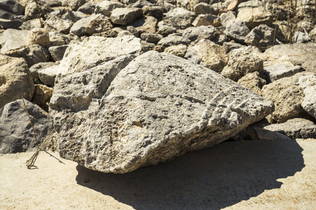 a large stone against a background of small stonesの写真素材