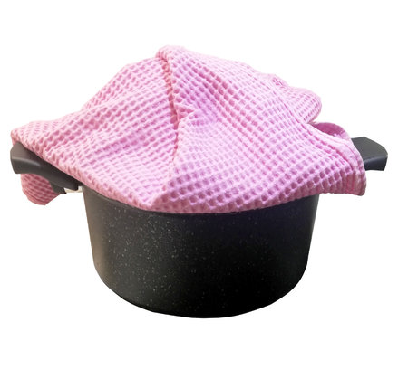 Gray saucepan with a lid covered with a pink towel, isolated on white backgroundの写真素材