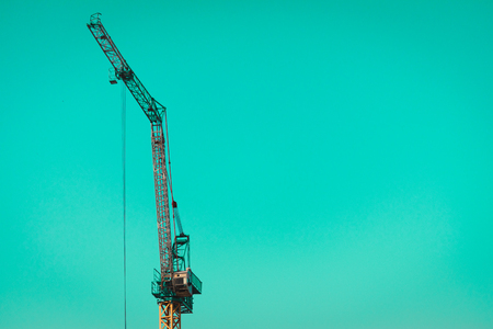 A Construction crane arm over green skyの写真素材