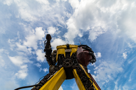 Yellow hand-made robot with blue sky.の写真素材