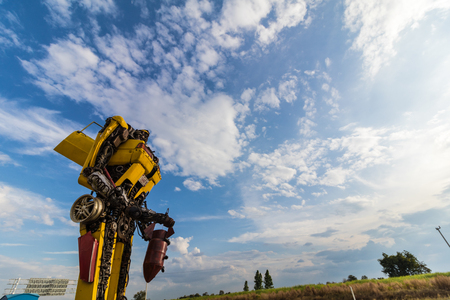Yellow hand-made robot with blue sky.の写真素材
