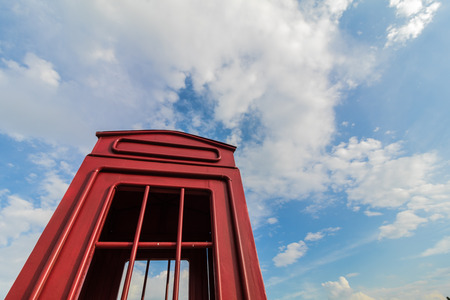 Red phone booth and blue sky.の写真素材