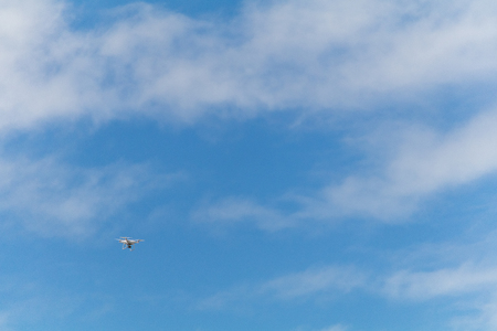 Drone flying in the blue sky.の写真素材
