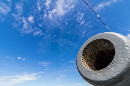 antique battle ship cannon with blue sky.の写真素材