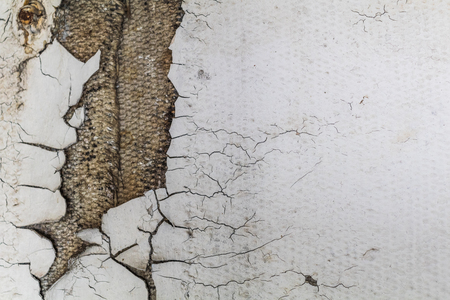 old cracked white wall broken.の写真素材