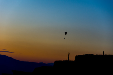 a man paragliding over the amphitheater ruins in the Pamukkaleの写真素材