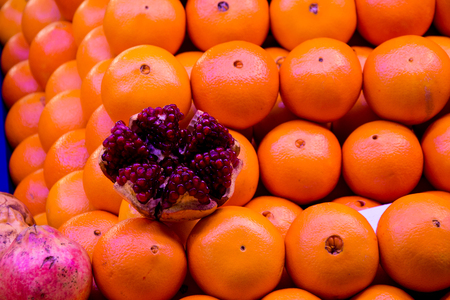 a bunch of mandarin clustered in rows and decorated with open and succulent narの写真素材