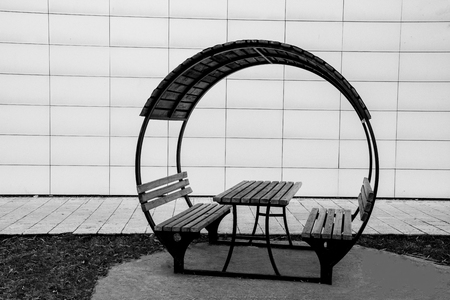 wooden banches and the table together covered by wooden roof in the gardenの写真素材