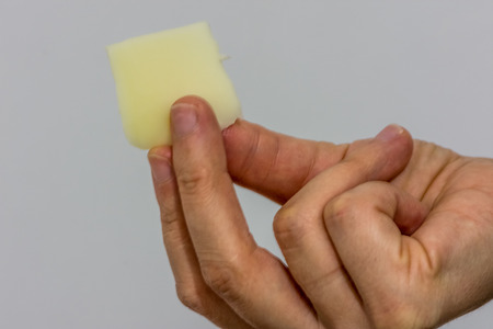 woman holding the small slice of the turkish cheeseの写真素材
