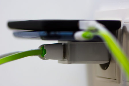 Two mobile phones charging pluged into the charger