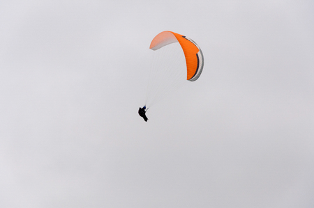 Image of parachute with parachutist skydiver in the skyの写真素材