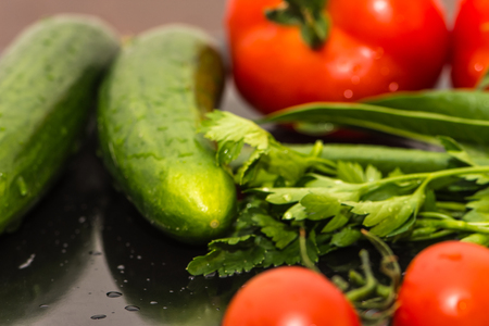 Some kind of vegetables on the kitchen table ready for making salatの写真素材