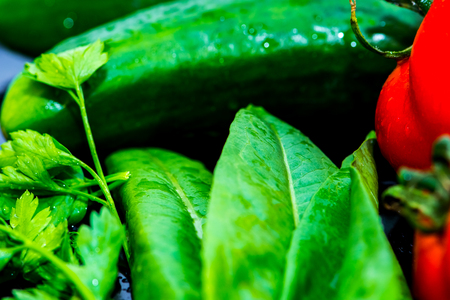 Some kind of vegetables on the kitchen table ready for making salatの写真素材