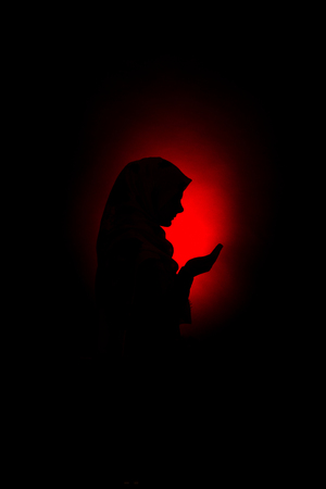 silhouette of a muslim woman praying to Allahの写真素材