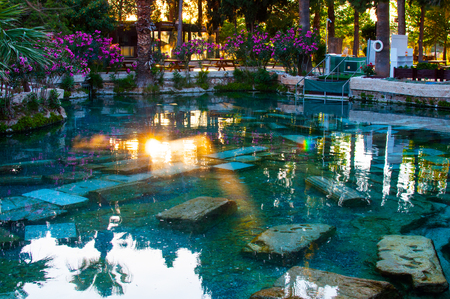 Sun reflection in the thermal swimming pool, touristic destination Pamukkale in Turkeyの写真素材