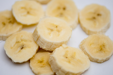 The small slices of ripe  bananas on the white backgroundの写真素材