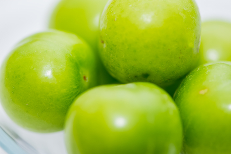 The small turkish green plums on the white background in the studioの写真素材