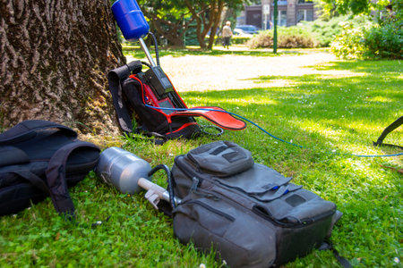 Equopment of a news crew in a park left on grass while taking interview ready for live broadcasting