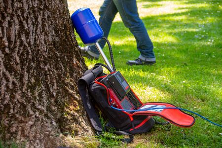 Equipment of a news crew in a park left on grass while taking interviewの写真素材