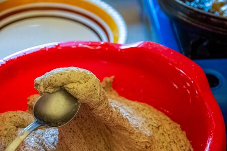 Taking dough of wheat and buckweat by spoon to cook frittersの写真素材