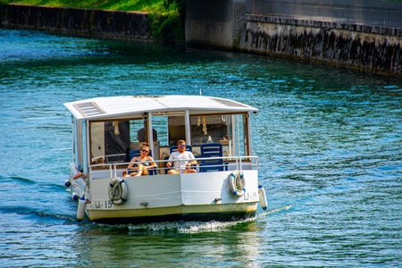 Beautiful toutist couple enjoy in sightseeing while driving on the boat on Ljubljanica river flowing in the center of Ljubljana capital city of Slovenia, 2019.07.26のeditorial素材