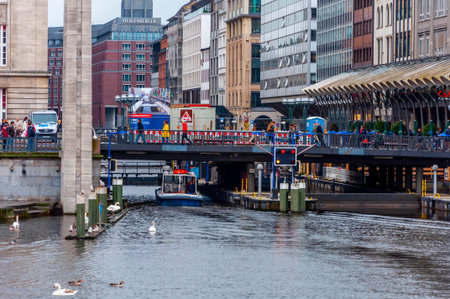 Hamburg, Germany, May 08. 2014. People walking on the bridge under reconstrution and boat under the...