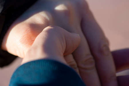 Close up of European romantic couple in love holding each other hands showing love and support. Relationships goal concept.の写真素材