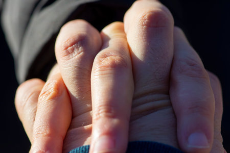Close up of European romantic couple in love holding each other hands showing love and support....