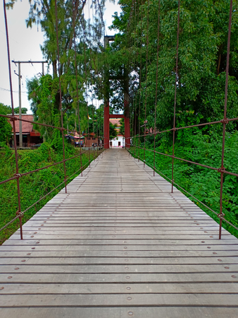 Suspention bridge across river.の写真素材