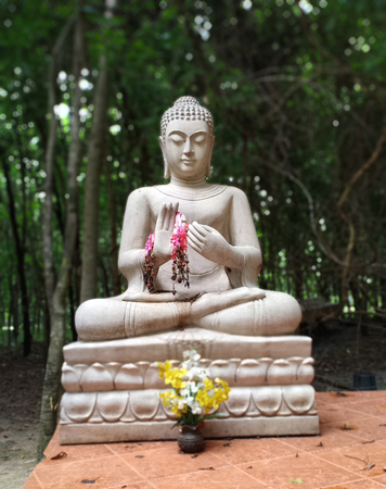 Buddha statue in forest.の写真素材