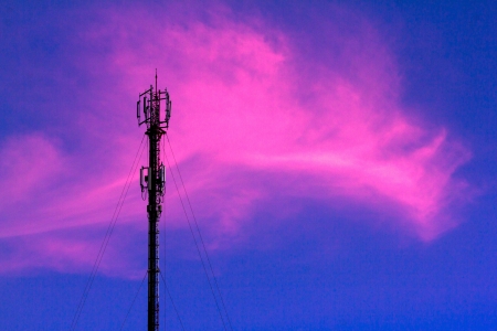 Telephone poles with pink clouds in the evening の写真素材