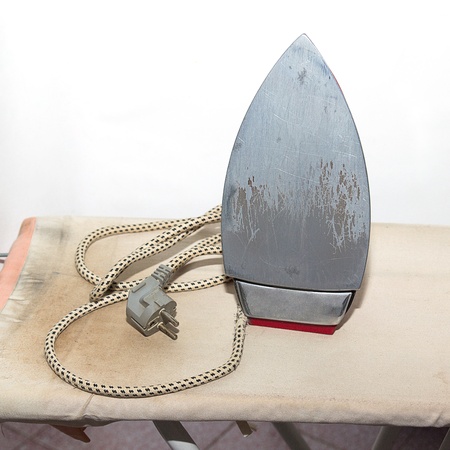 Iron and ironing board on a pedestal dirty の写真素材