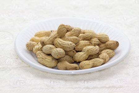 Peanuts a plate on the tablecloth 