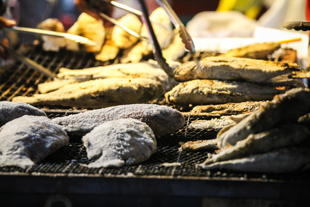 Grilled fish with salt paint put on the market at night の写真素材