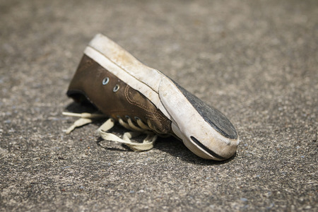 Old shoes on the cement floor の写真素材