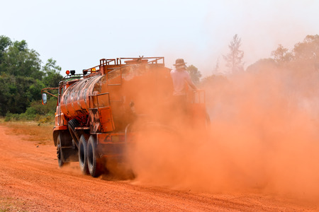Dust caused by the car running in the summer.の写真素材