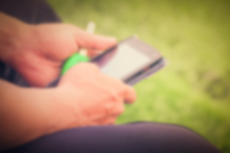 Blurred man holding a mobile phone With vintage styleの写真素材