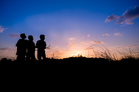 child on sky background in the eveningの写真素材