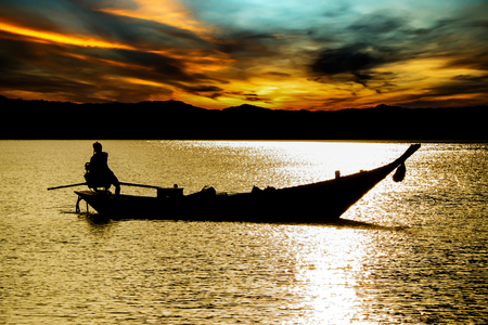 fisherman on boat in the morning.の写真素材